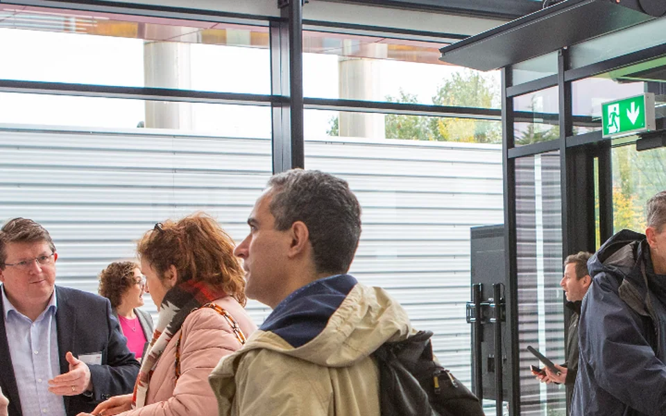 IRDG members talking over coffee in the glass-walled atrium at Logitech's Cork site.